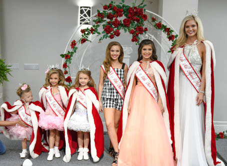 Photo of pageant winners in dresses and formal robes