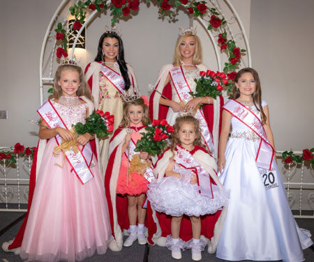 Photograph of pageant winners wearing formal gowns.